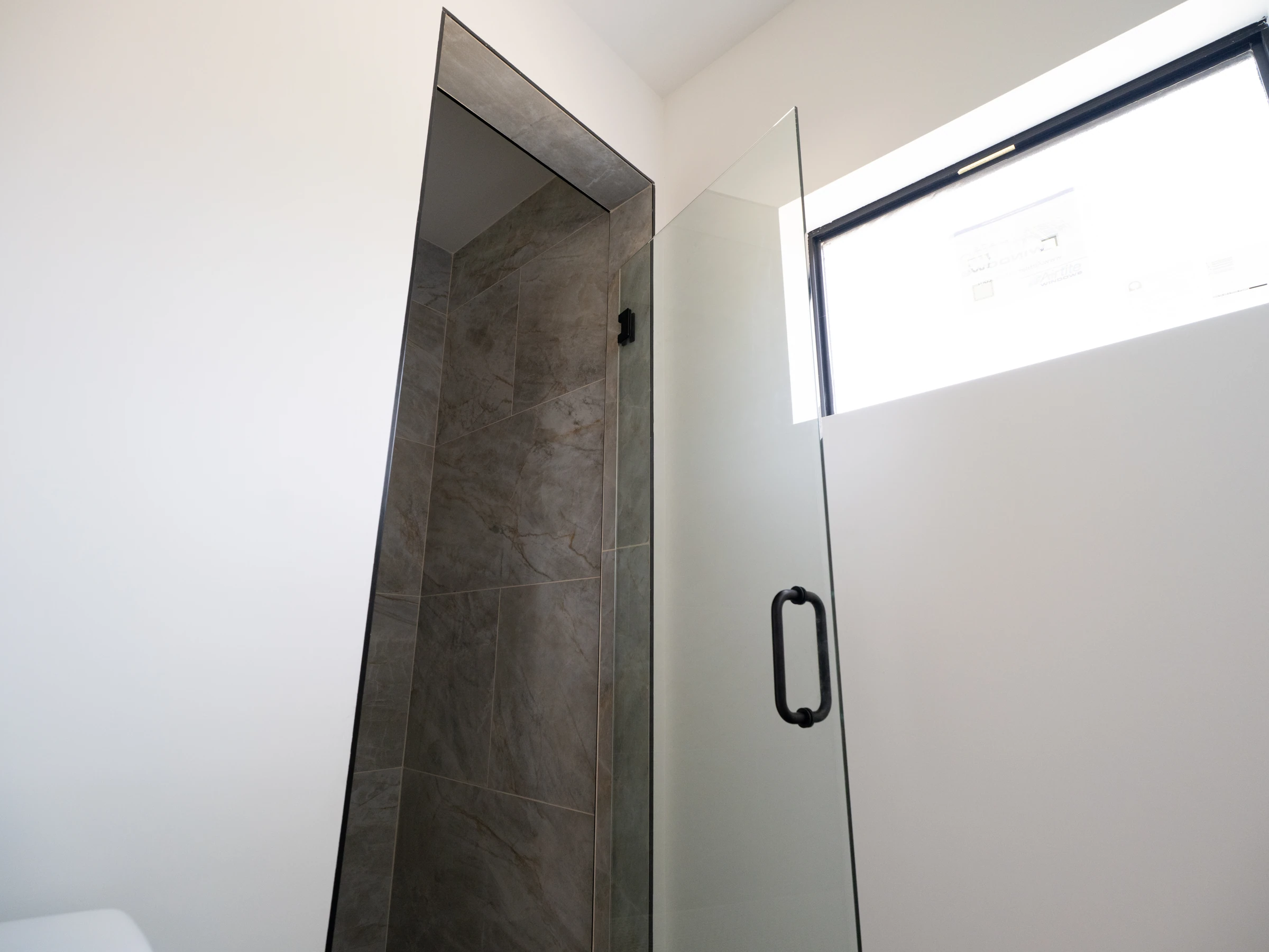 Frameless shower glass door in a modern Austin bathroom